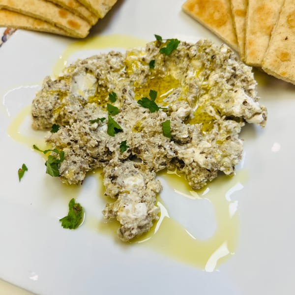 Greek Lady's creamy eggplant dip with olive oil and parsley, served with pita bread.